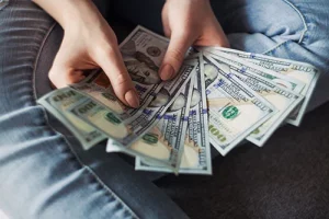 Woman Fanning $100 Bills