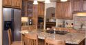 Kitchen island with wooden chairs around it